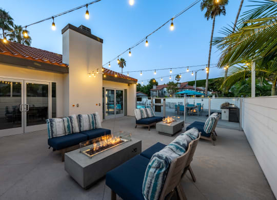 a patio with couches and chairs and a fire pit  at Laguna Gardens Apts., Laguna Niguel, CA, 92677