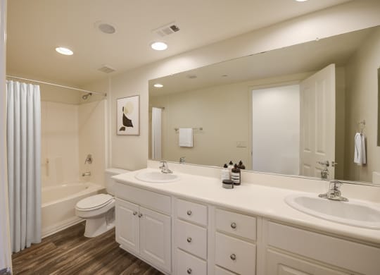 a bathroom with white cabinets and a white shower curtain  at Monarch at Dos Vientos, Newbury Park, CA