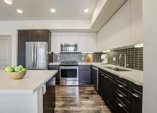 A modern kitchen with stainless steel appliances at Montecito at Carlsbad, Carlsbad, CA 92010