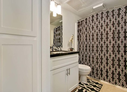 a bathroom with a black and white shower curtain  at Masselin Park West, California