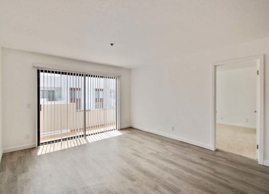 an empty living room with a large window  at Masselin Park West, Los Angeles
