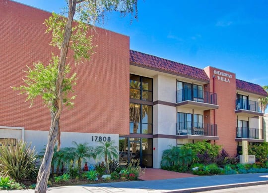 a large brick building with a tree in front of it  at Sherway Villa, Reseda