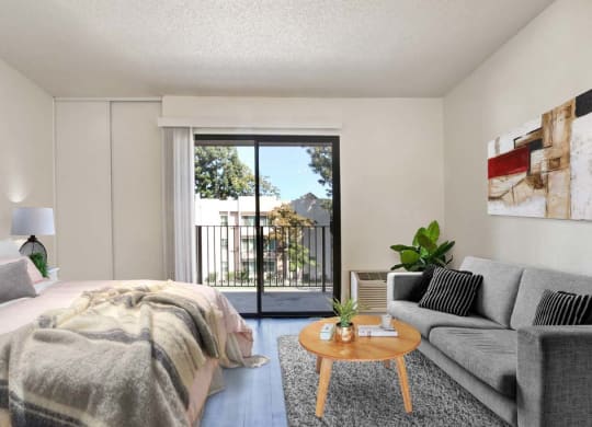 a bedroom with a bed and a couch in front of a sliding glass door  at Sherway Villa, Reseda, California