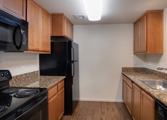Kitchen with wooden cabinets at Meadow Wood at Alamo Creek, California