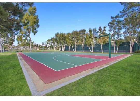 the basketball court is located in the middle of the park  at Harvard Manor, Irvine, 92612