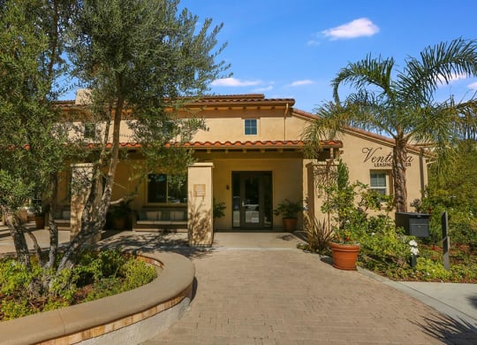 a building with a porch and trees in front of it at Ventana Senior Apartments, California, 91326