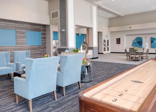 a room with a shuffleboard table and blue chairs  at Deer Creek Apartments, San Ramon, 94582