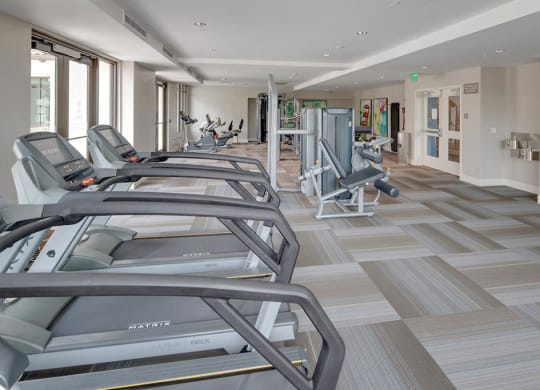 a gym with treadmills and other exercise equipment  at Deer Creek Apartments, San Ramon