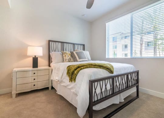 Bedroom with cozy bed  at Montecito Apartments at Carlsbad, California