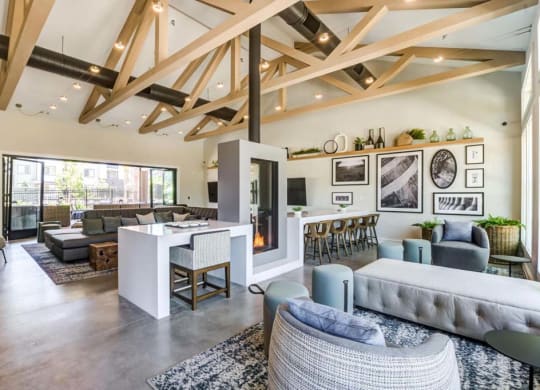 a living room filled with furniture and a large window at The Vineyards Apartments, Porter Ranch