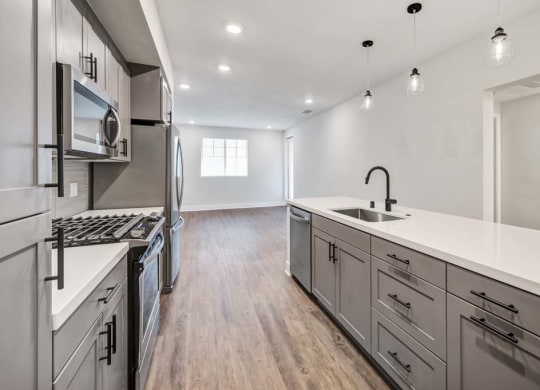 a kitchen with a stove top oven at The Vineyards Apartments, Porter Ranch, CA