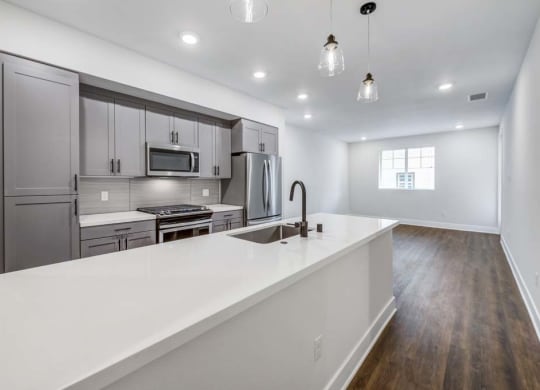 a kitchen with a sink and a stove in a house  at The Vineyards Apartments, California, 91326