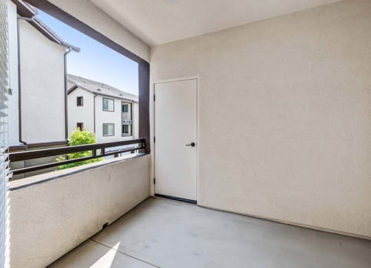 a room with a large window and a door at The Vineyards Apartments, Porter Ranch