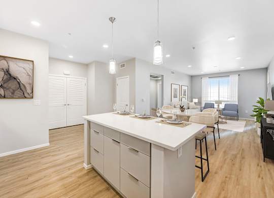 A modern kitchen with a large island and bar stools.