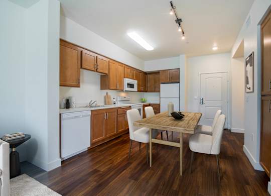 Kitchen with wooden floor and cabinets at Portola Senior Apartments, Carlsbad, 92010