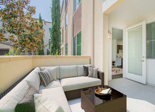 Patio with couch and firepit at Portola Senior Apartments, Carlsbad, CA