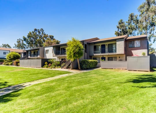a house with a green lawn in front of it  at Redlands Park Apts, California