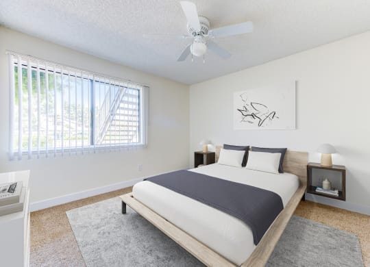 a bedroom with a bed and a ceiling fan at Redlands Park Apts, California