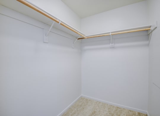 a walk in closet with white walls and gray carpet  at Seville at Gale Ranch, California, 94582