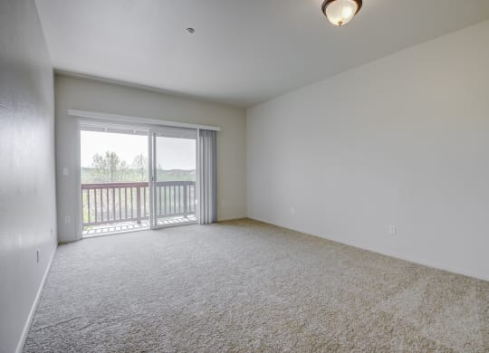 a bedroom with a sliding glass door and a carpeted floor  at Seville at Gale Ranch, San Ramon, 94582