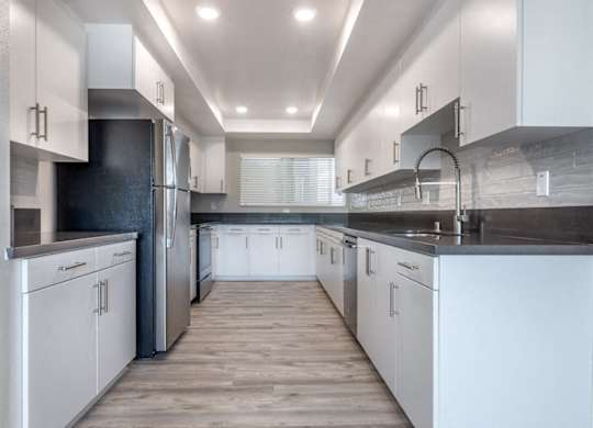 Kitchen with stainless steel appliances at Bixby Hill Apartments, Long Beach, California