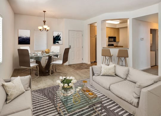 a living room with a couch and a table with chairs  at Falcon Bridge at Gale Ranch, California, 94582
