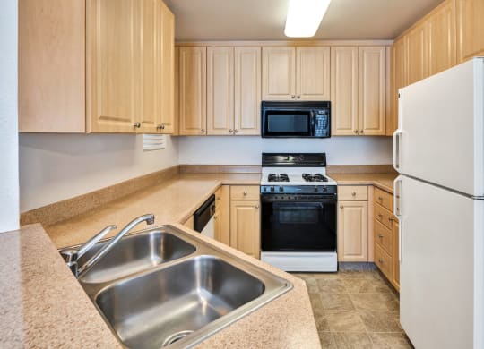 a kitchen with a sink stove refrigerator and microwave  at Falcon Bridge at Gale Ranch, San Ramon, CA