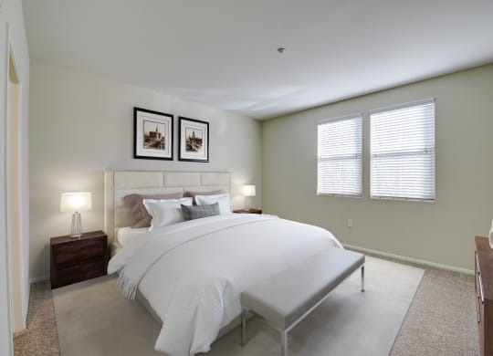 a bedroom with a large bed and two windows  at Sonoma at Porter Ranch, Porter Ranch, CA