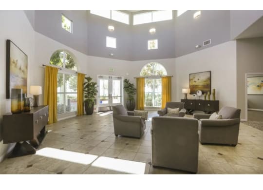 a large living room with couches and chairs  at Tesoro Senior Apartments, Porter Ranch, CA, 91326