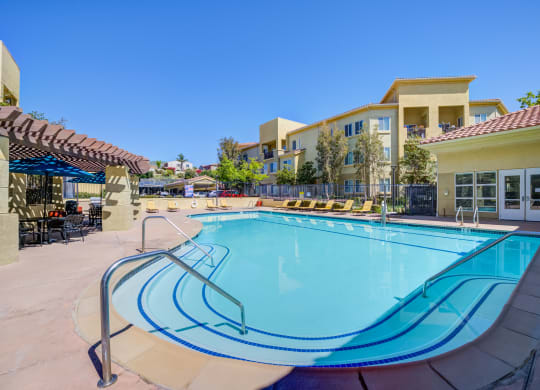take a dip in our resort style swimming pool  at Tesoro Senior Apartments, Porter Ranch