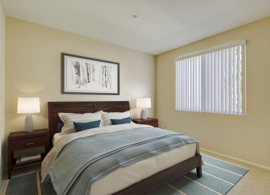 a bedroom with a large bed and two night stands with lamps  at Tesoro Senior Apartments, Porter Ranch, California