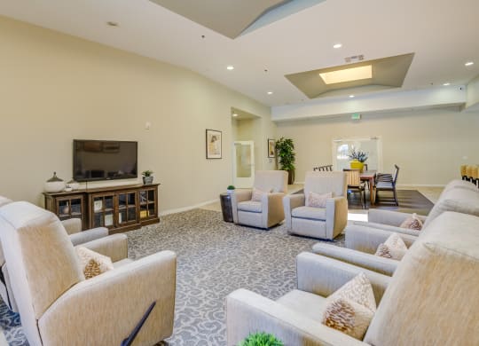 a living room filled with furniture and a flat screen tv  at Tesoro Senior Apartments, California