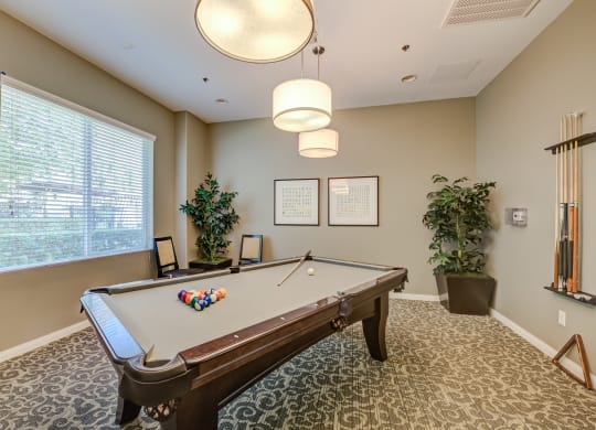 a resident clubhouse with a pool table  at Tesoro Senior Apartments, California, 91326