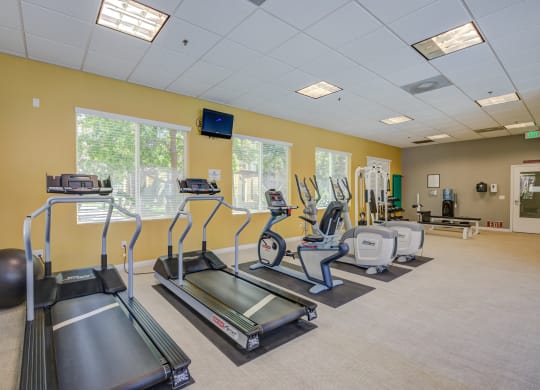 a room filled with lots of exercise equipment at Tesoro Senior Apartments, California