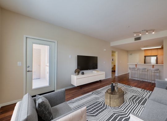a living room with door leading to balcony at Ventana Senior Apartments, California, 91326