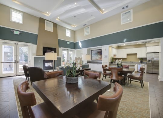 a resident clubhouse with a fireplace and dining table  at Ventana Senior Apartments, California, 91326