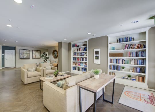 a living room filled with furniture and a large bookshelf  at Ventana Senior Apartments, Northridge, CA, 91326