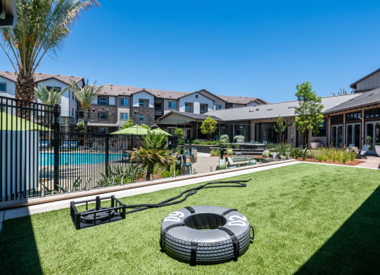 a backyard with a pool and a fire pit at The Vineyards Apartments, Porter Ranch, California