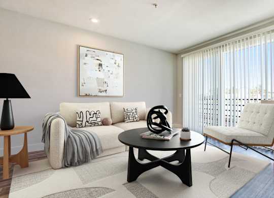 A living room with a white couch and a black coffee table.