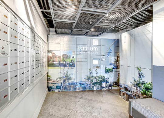 a locker room with white lockers and a mural on the wall at Atrium, Los Angeles, CA