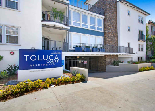a building with a toluca court apartments sign in front of it at Toluca Court, Toluca Lake, CA