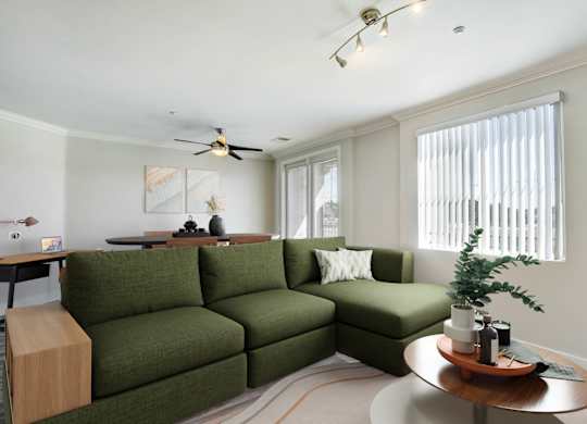 A living room with a green couch and a wooden side table. at Apex Mission Valley, California, 92108