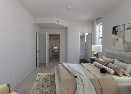 A bedroom with a large bed and a painting on the wall at Burton Apartments, Los Angeles, 90048