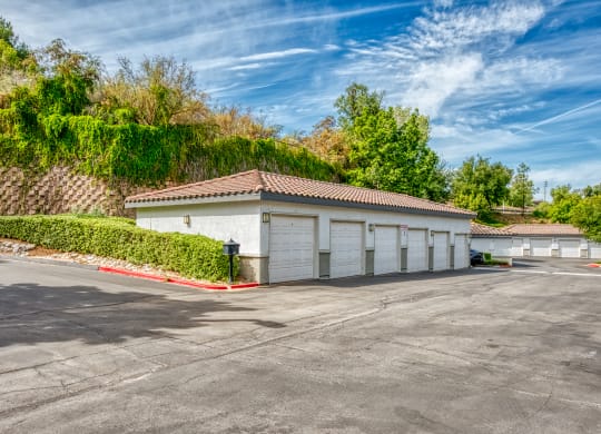 a garage with white doors and a parking lot at Canyon Crest, Riverside, CA