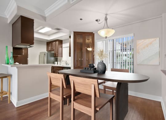 an open kitchen and dining room with a table and chairs  at Darlington Apartments, California