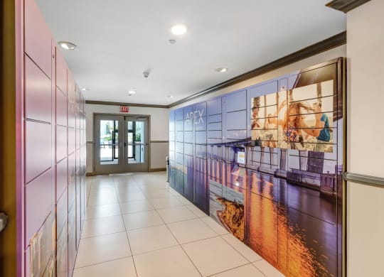 a hallway with a large mural on the wall and a door at the end of the hallway  at Apex Mission Valley, San Diego, California