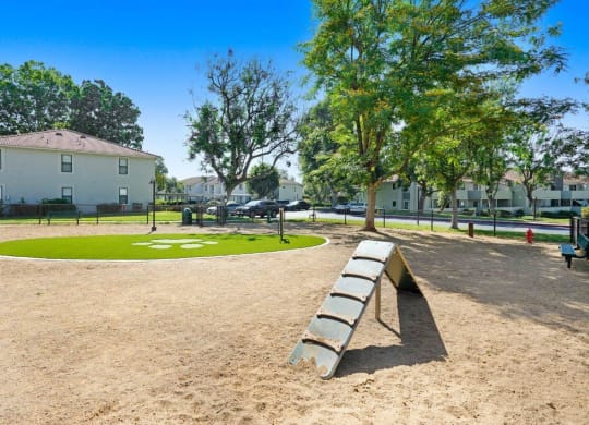 a park with a bench and a grassy area in front of a building at The Park Apartments, Rancho Cucamonga, California