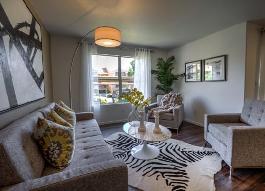 a living room with a zebra rug and couches at Bella Terra Apartments, Nevada