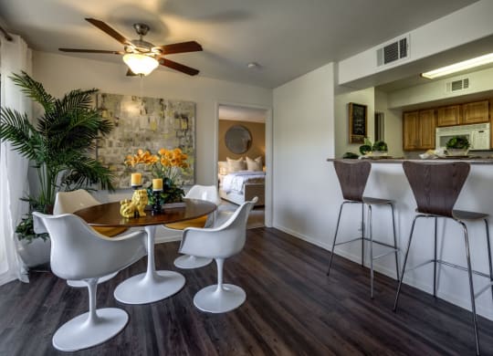 a living room and kitchen with a bar and a table at Bella Terra Apartments, Nevada