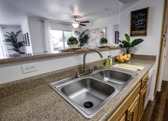 a kitchen with a sink and a counter top at Bella Terra Apartments, Henderson, NV, 89012